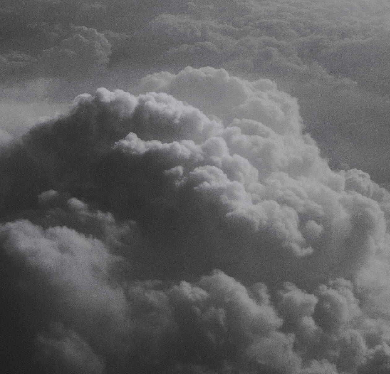 A large, greyscale cloud. It gets lighter at the top and darker at the bottom, and seems to be mostly in the sun.